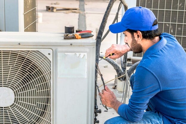 A view of a contractor fixing a HVAC AC outer