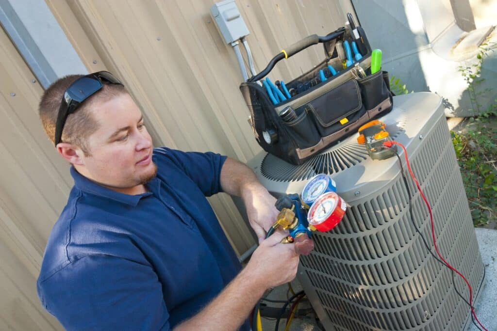 A view of a guy fixing the HVAC system