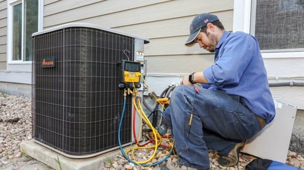 A view of a technician fixing a HVAC unit