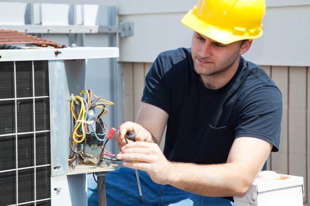A view of a technician fixing an HVAC system