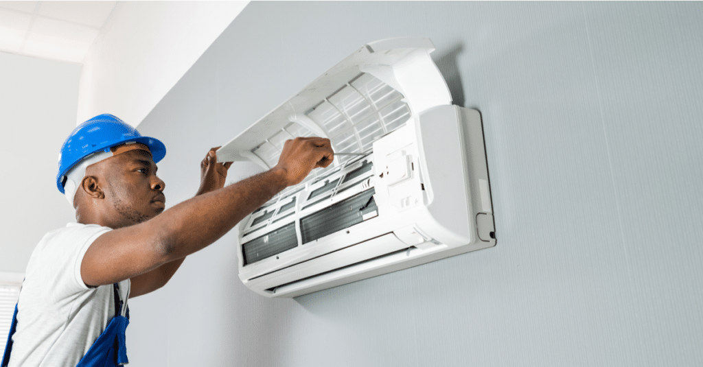 A view of a technician fixing an AC