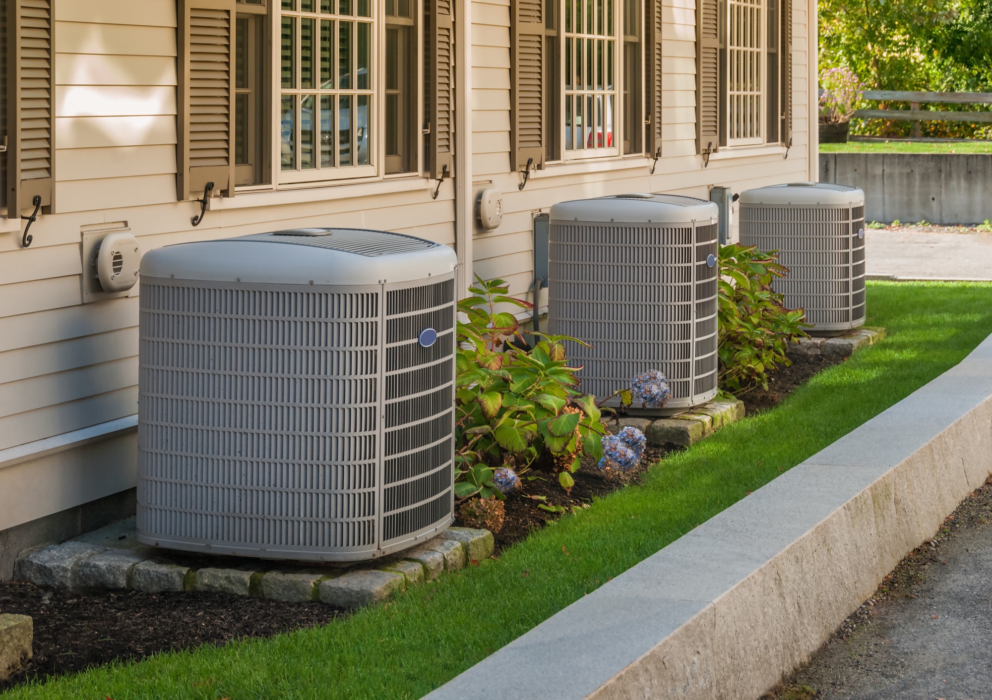 A view of various kinds of AC units placed inside a house garden